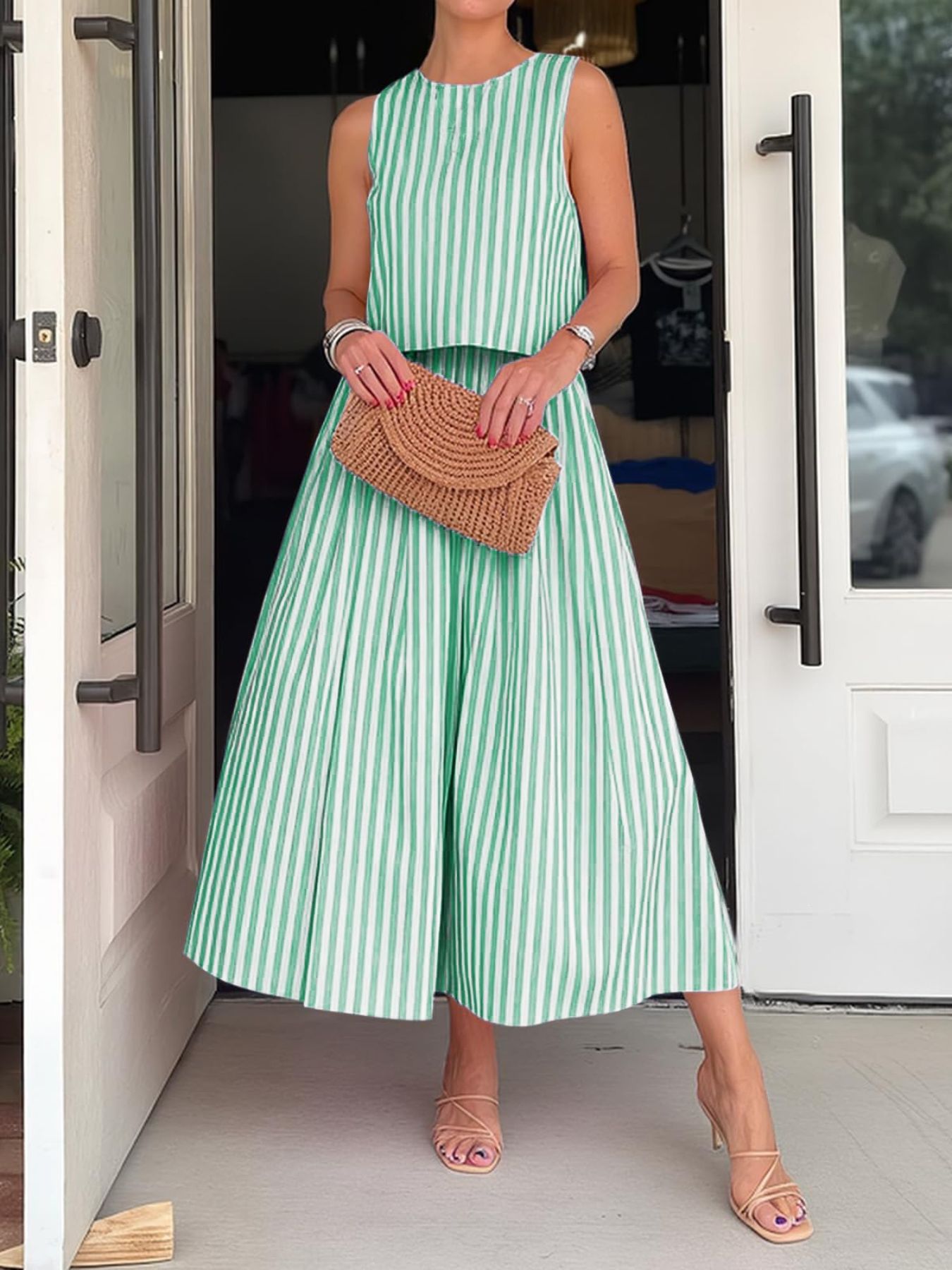 Women's striped sleeveless top and midi skirt two-piece set by Trendsi, featuring a stylish coordinated outfit with bold pattern.