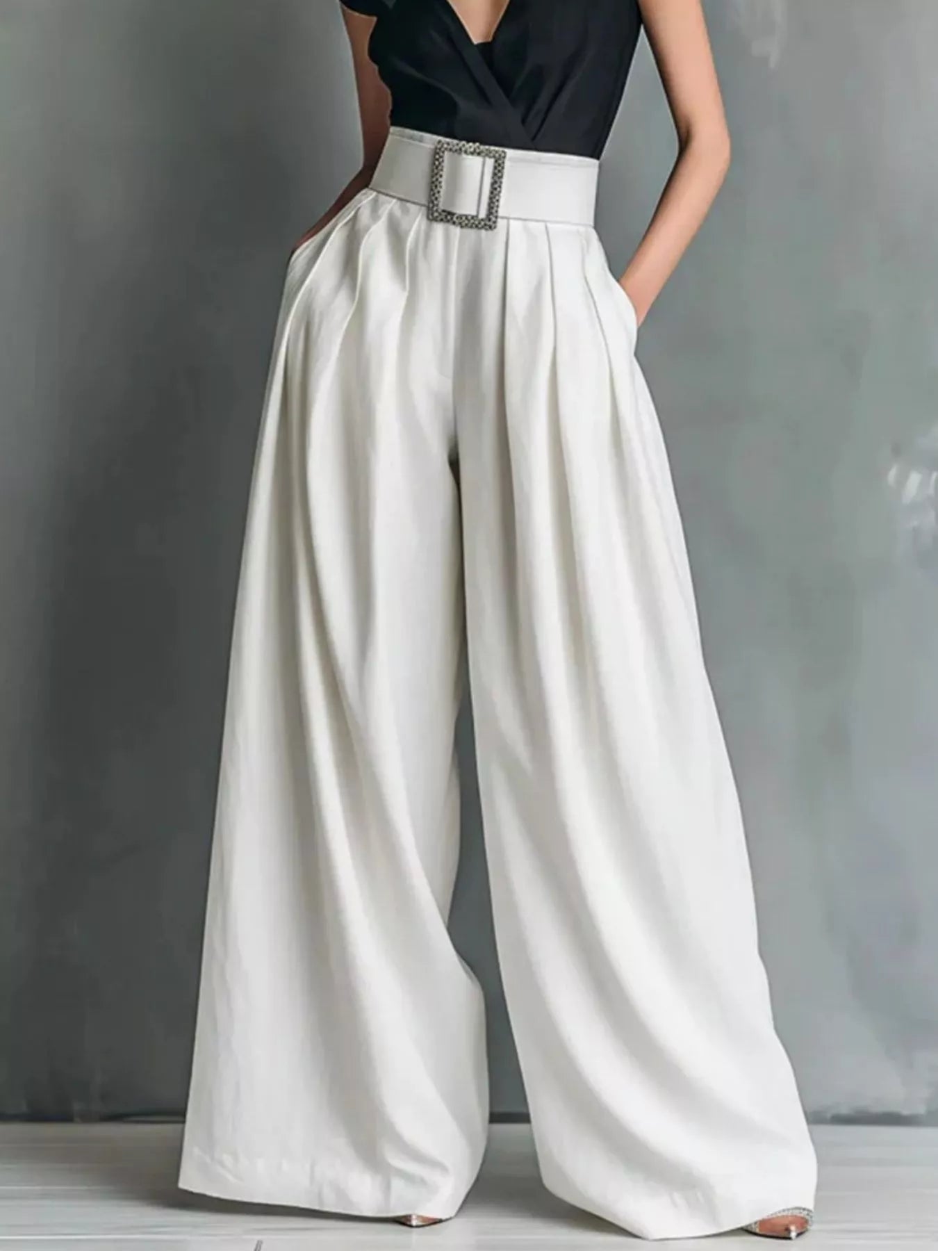 High-waisted wide-leg pants from Plush Fashion Hub displayed on a hanger, showcasing their flowy silhouette and stylish fit.