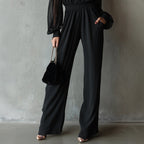 Black embroidered women's long-sleeve wide-leg jumpsuit from Plush Fashion Hub, casualwear with intricate embroidery and flowing wide-leg design.