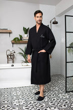 Black men's waffle spa bathrobe from Plush Fashion Hub, lightweight and absorbent, perfect for relaxing after a shower.