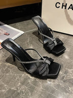 Elegant women's mid-heel sandals with bow detail in faux leather, featuring a stylish and comfortable design by Trendsi.
