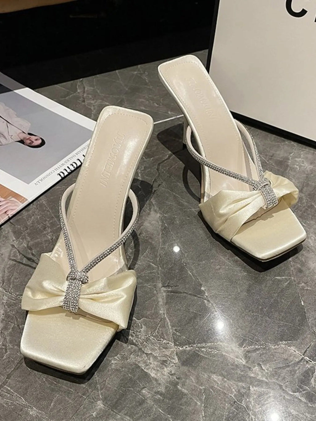 Elegant faux leather women's mid-heel sandals with bow detail, stylish and comfortable shoe by Trendsi.