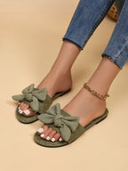 Women's open toe flat sandals with bow accent, trendy slip-ons by Trendsi, perfect for comfortable summer wear.