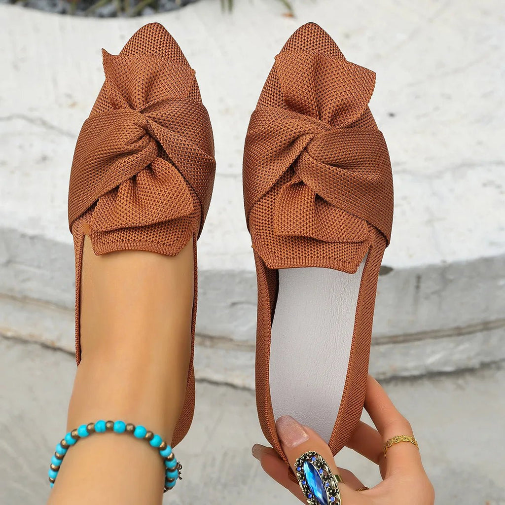 Elegant bow-embellished pointed toe flat slip-on shoes from Trendsi, featuring a stylish and comfortable design.