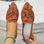 Elegant bow-embellished pointed toe flat slip-on shoes from Trendsi, featuring a stylish and comfortable design.