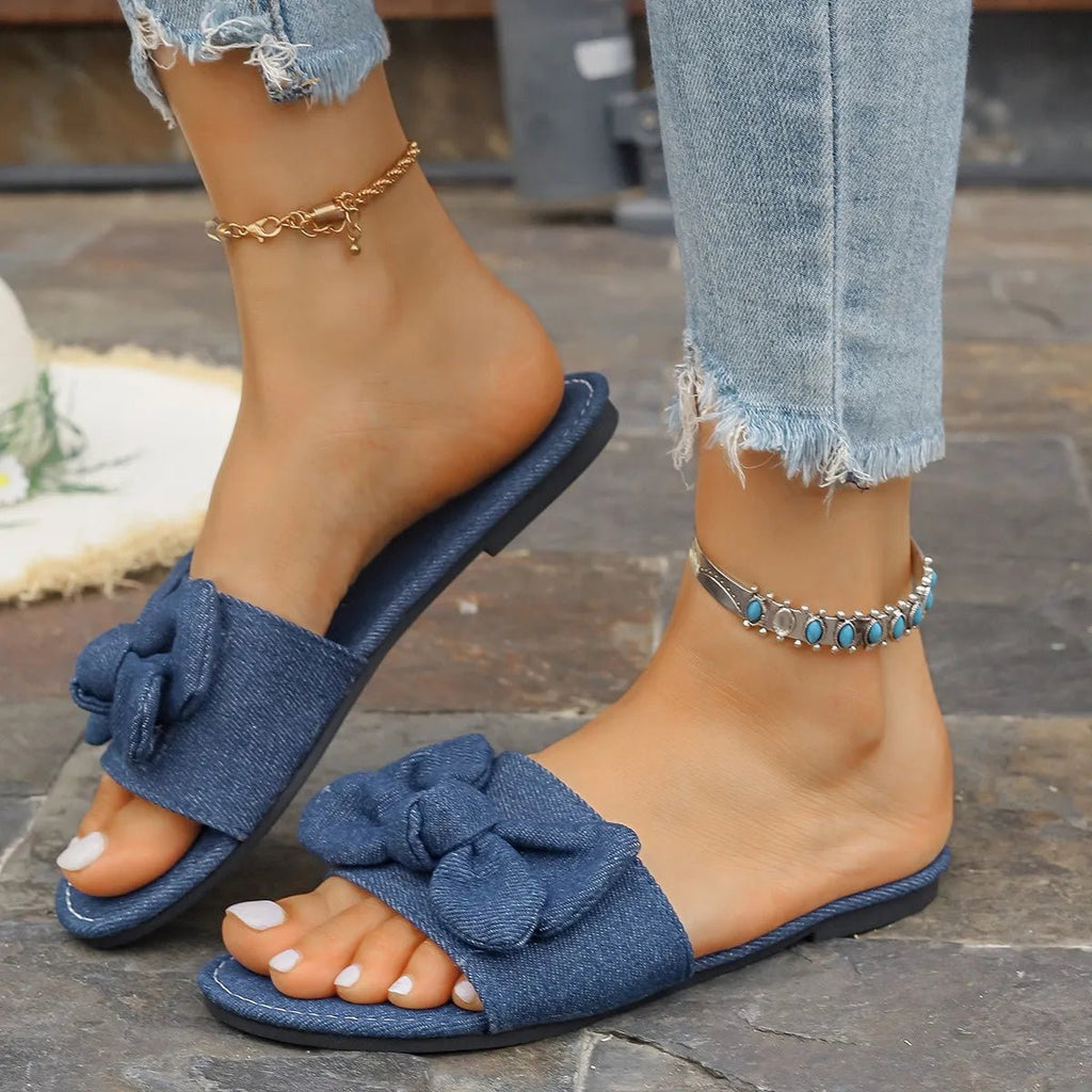 Women's denim bow tie flat sandals with casual PU leather straps, comfortable slip-on shoes by Trendsi.