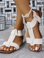 Women's PU leather flat sandals with buckle straps from Trendsi, featuring a comfortable and stylish slip-on shoe design.