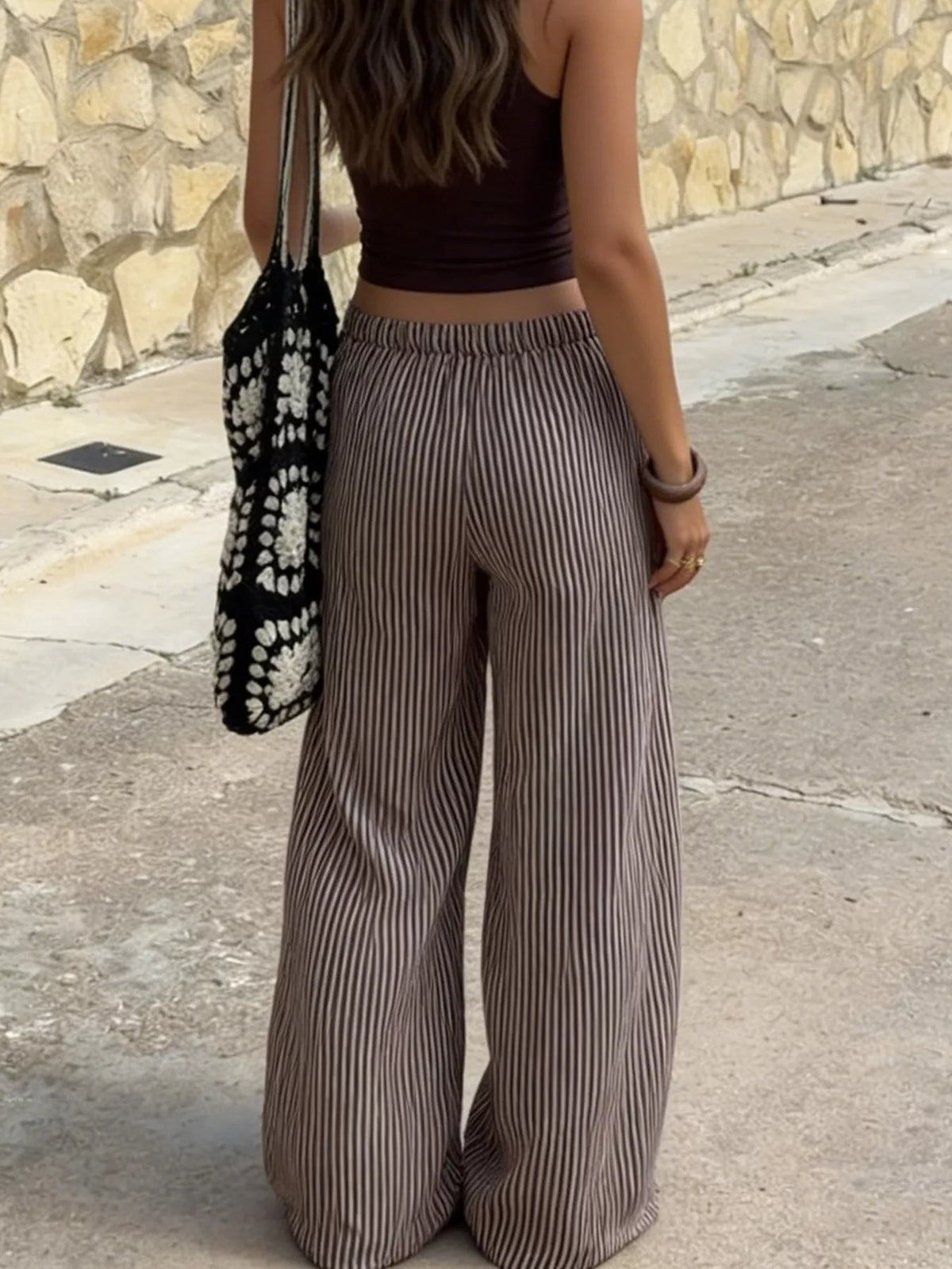 Plush Fashion Hub tied striped wide-leg pants, soft plush fabric, stylish bottoms with relaxed fit and bold striped pattern.