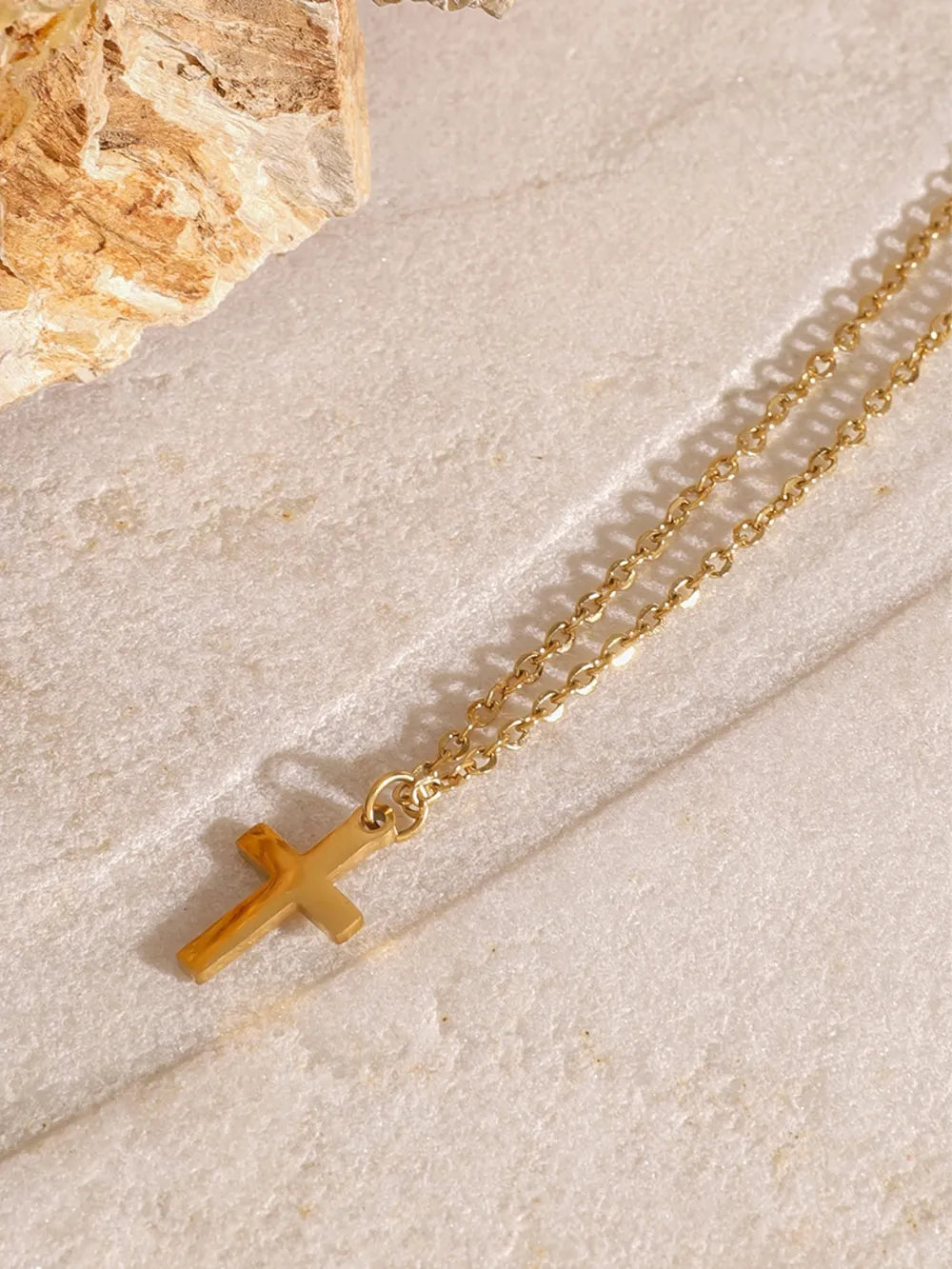 18K gold-plated three-layered cross necklace with delicate chain and detailed cross pendants, styled for elegant wear.