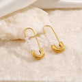 Shopimist safety pin earrings with elegant pearl accents, showcasing a modern jewelry design with shiny metal and pearl details.