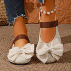 Women's chic bow round toe slip-on flats made of vegan leather from Trendsi, featuring a stylish design and comfortable fit.