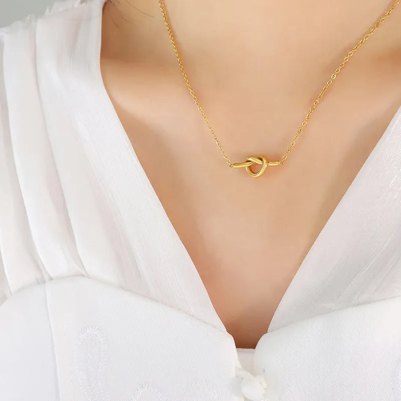 18K gold-plated titanium steel knot necklace with a sleek, polished finish, showcasing its elegant, intertwined design.