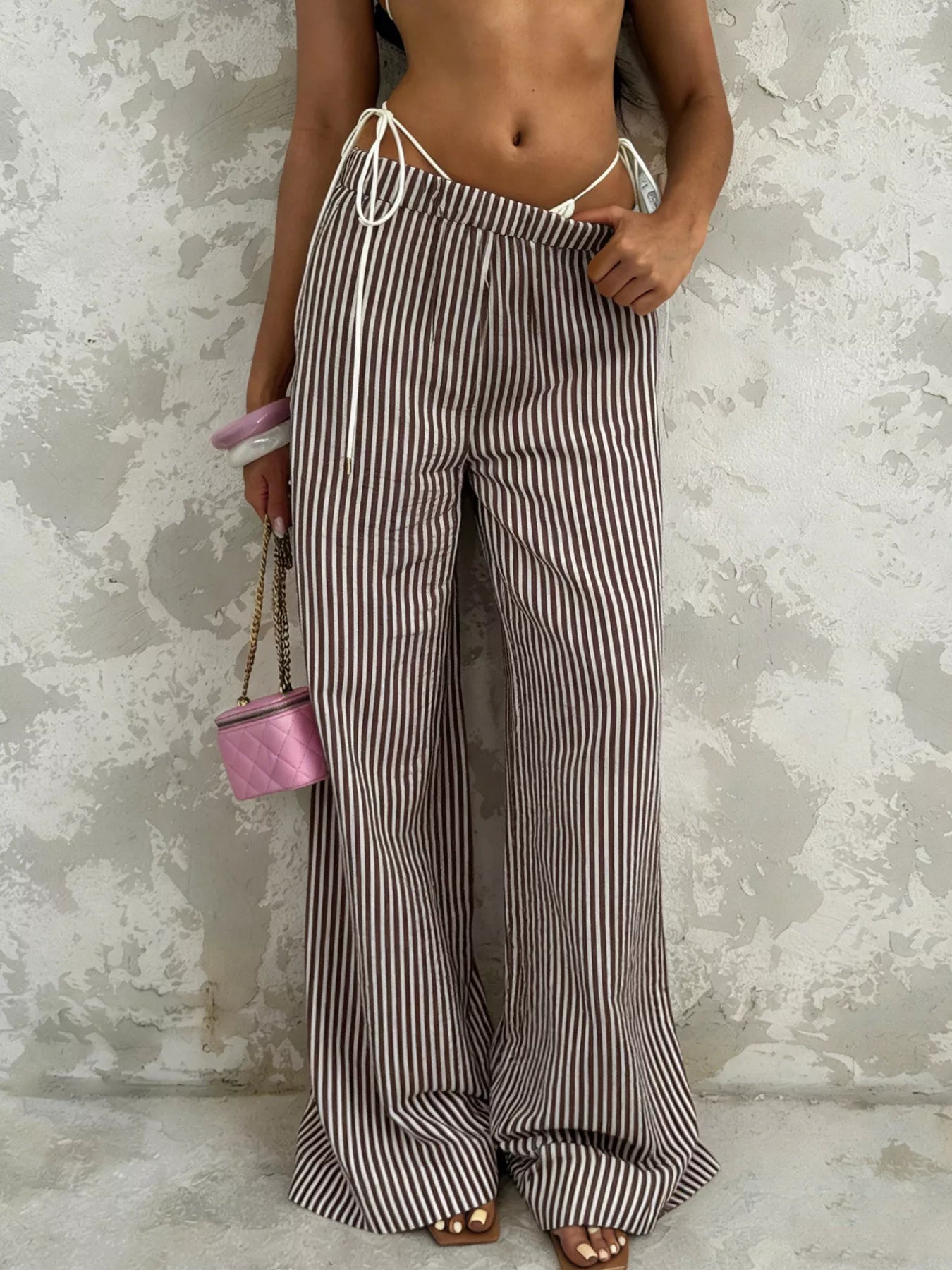 Plush Fashion Hub tied striped wide-leg pants, stylish bottoms with a relaxed fit and bold horizontal stripe pattern.