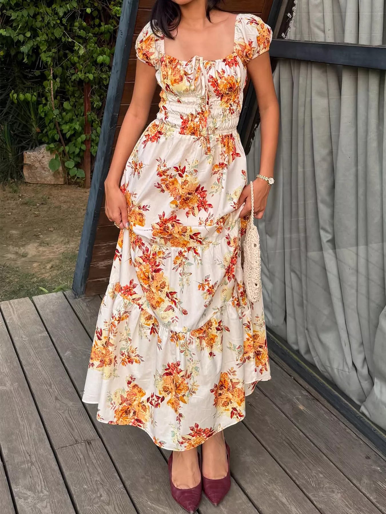 Women's floral print short sleeve ruched maxi dress by Trendsi, featuring a flowy design and vibrant floral pattern.