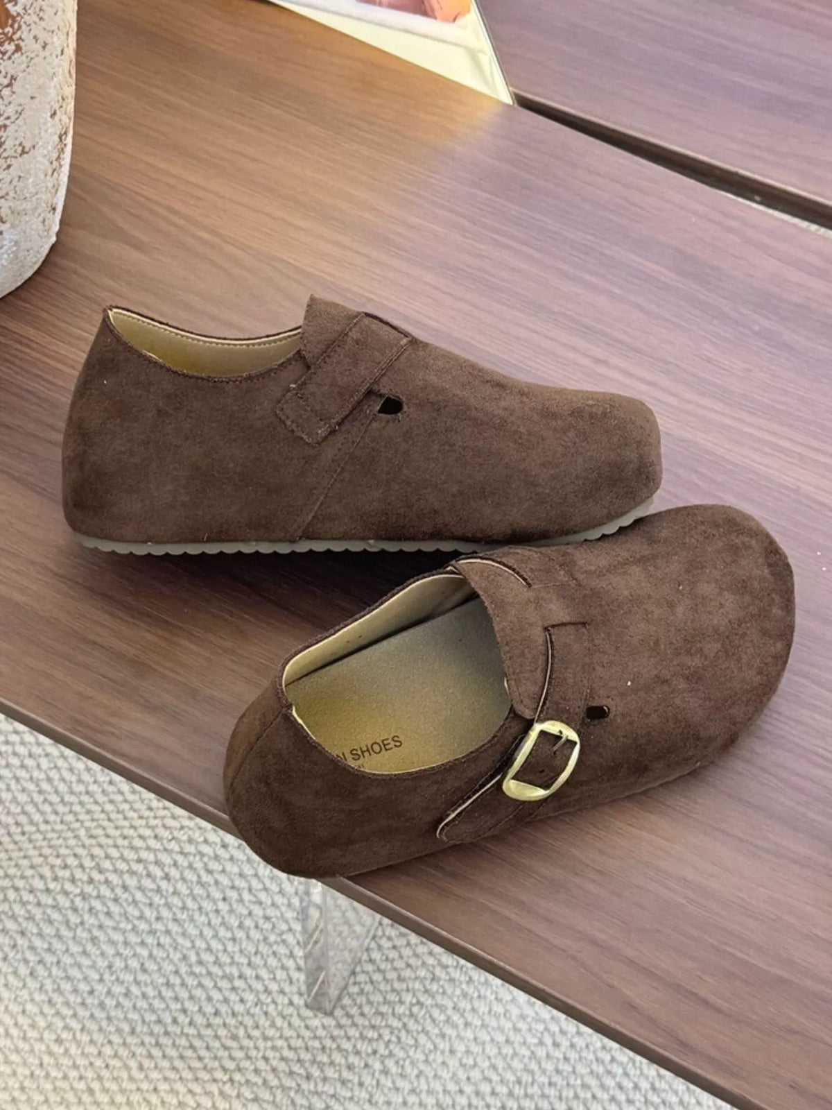 Women's suede buckle slip-on shoes by Trendsi featuring a stylish, comfortable design with a buckle detail and slip-on style.