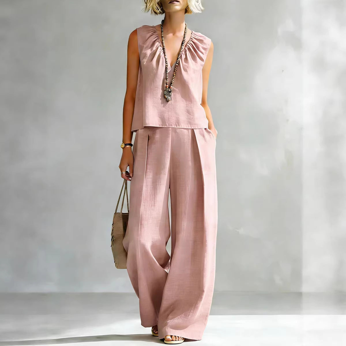 Women's sleeveless cotton-linen shirt and pants set by FitiqueFit, casual urban two-piece outfit, shown in light fabric and relaxed fit.