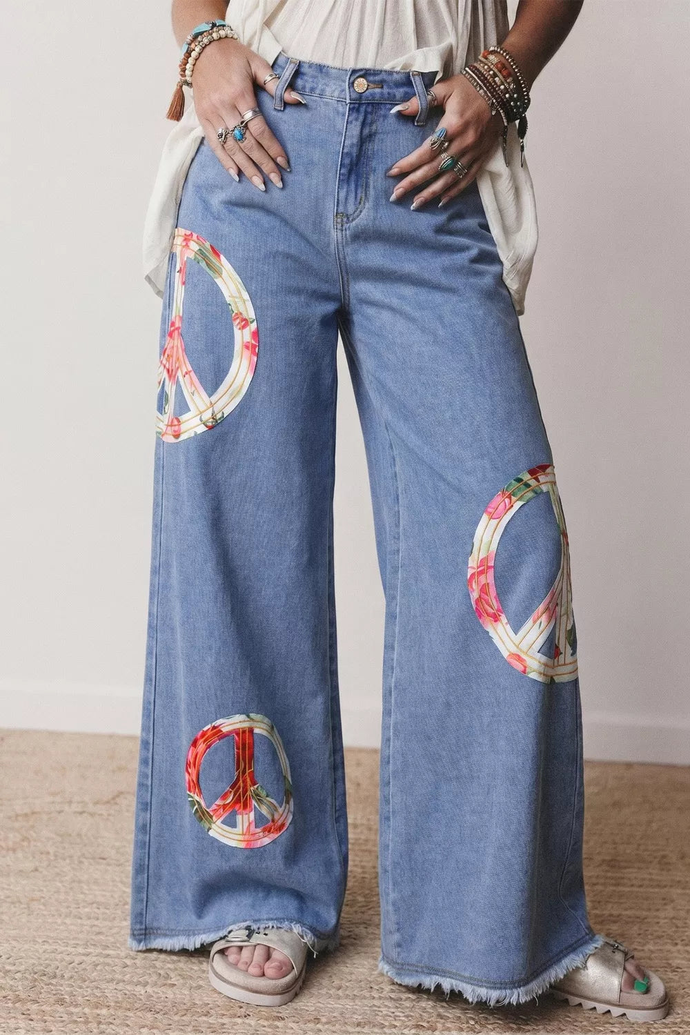 Floral Peace Sign wide-leg jeans by Plush Fashion Hub featuring colorful floral embroidery and relaxed fit.