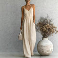 Women's sleeveless wide-leg jumpsuit by FitiqueFit in five colors, displayed on a hanger with front view and relaxed fit.