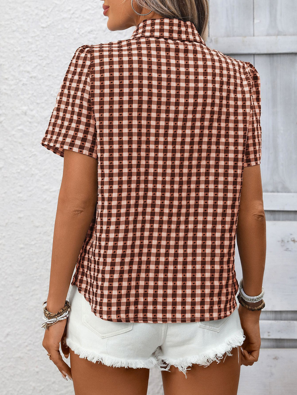 Women's lightweight plaid button-up short sleeve shirt by Trendsi, featuring a classic checkered pattern and casual fit.