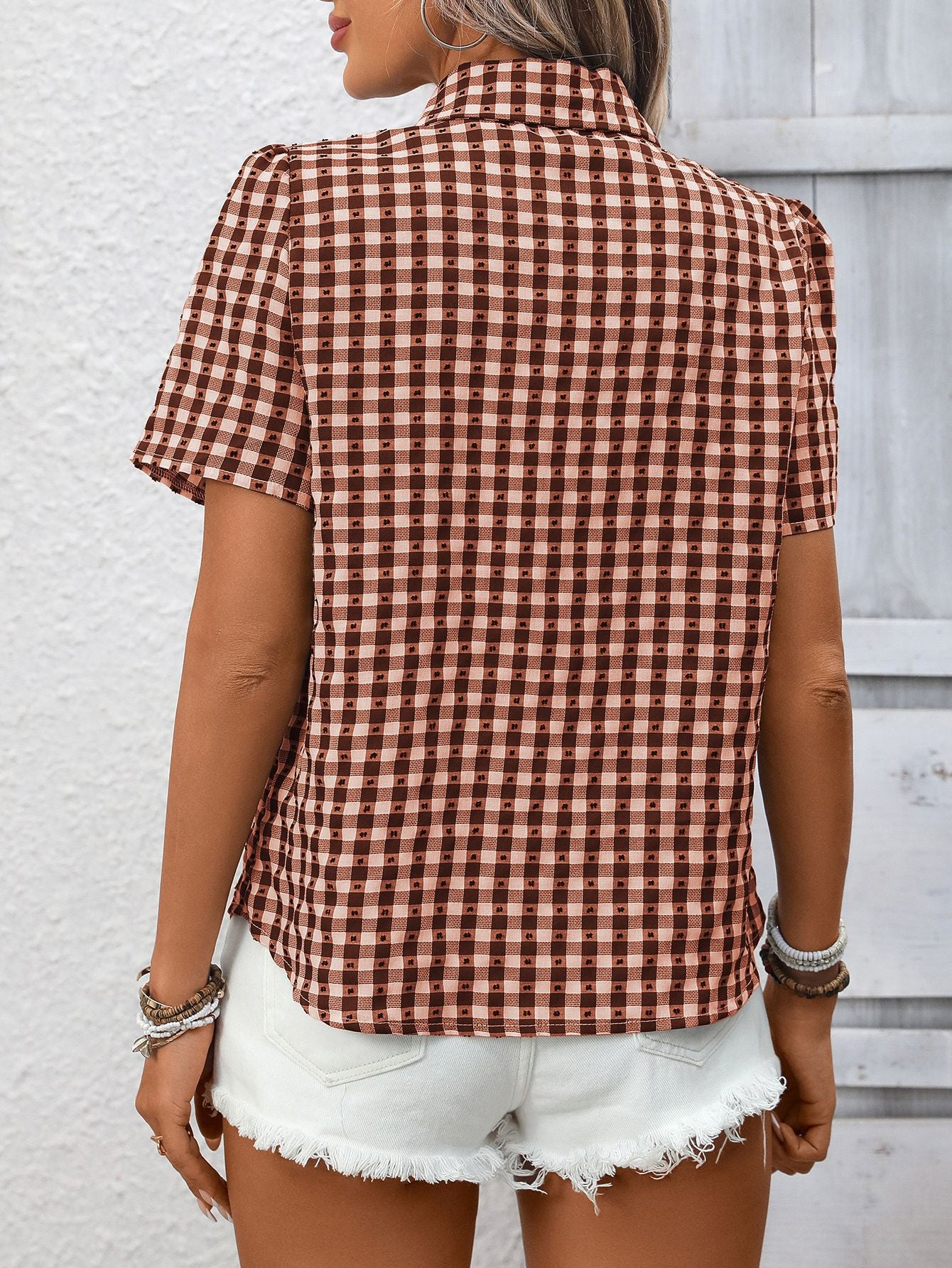 Women's lightweight plaid button-up short sleeve shirt by Trendsi, featuring a classic checkered pattern and casual fit.