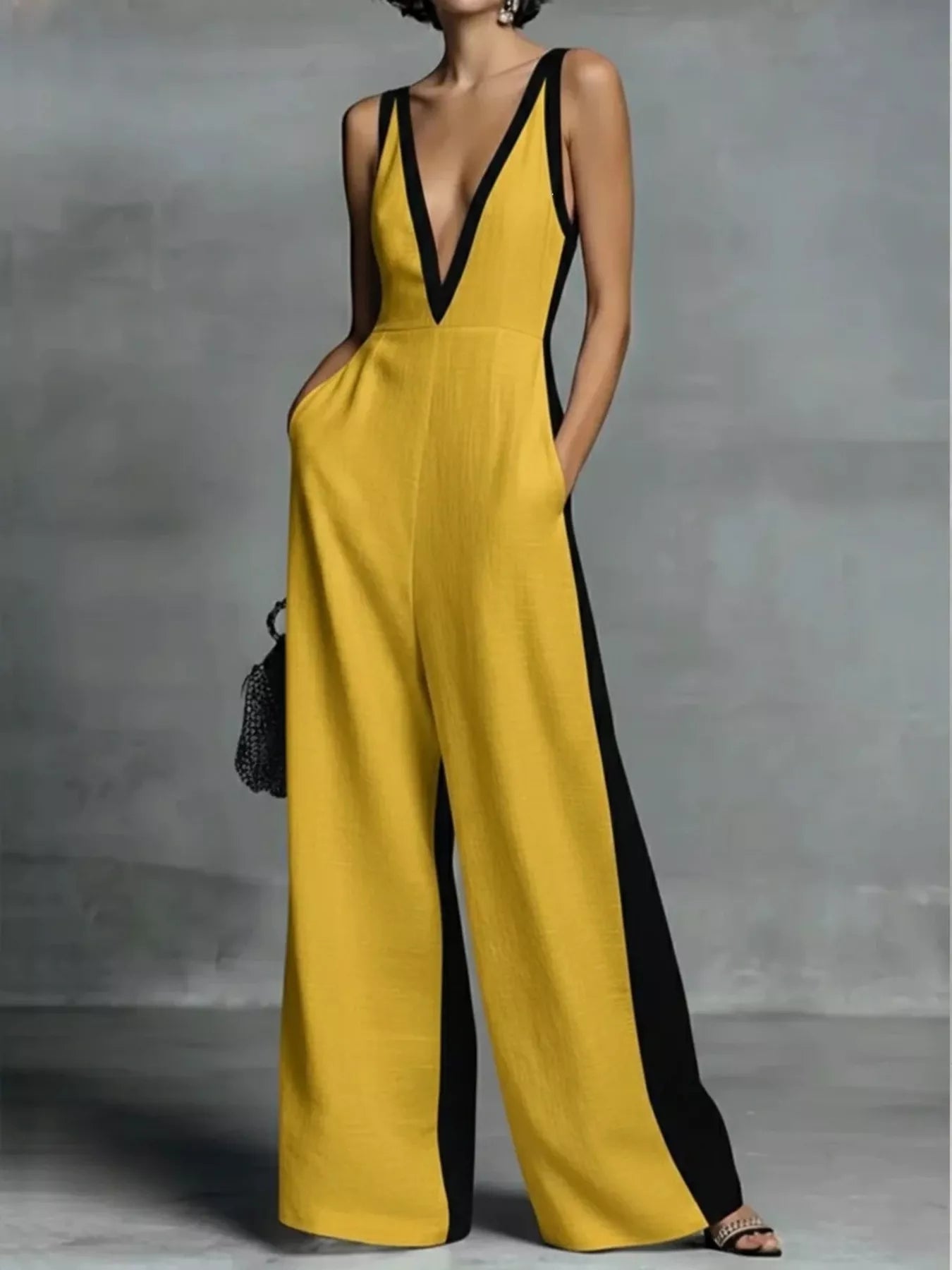 Deep V-neck wide-leg jumpsuit, trendy onesie by Trendsi, featuring a stylish deep V-neckline and comfortable wide-leg design.