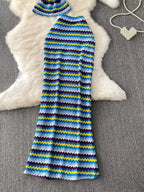 Women's striped knitted halter top and maxi skirt dress set by Trendsi, featuring a stylish, comfortable knit fabric and vibrant pattern.