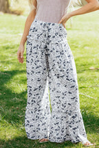 Light beige Hope wide-leg casual pants by Threaded Pear, featuring a relaxed fit and flowing fabric, shown on a model.