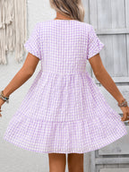 Plush Fashion Hub plaid V-neck mini dress with ruffle hem, lightweight seasonal fashion, styled for casual or semi-formal wear.
