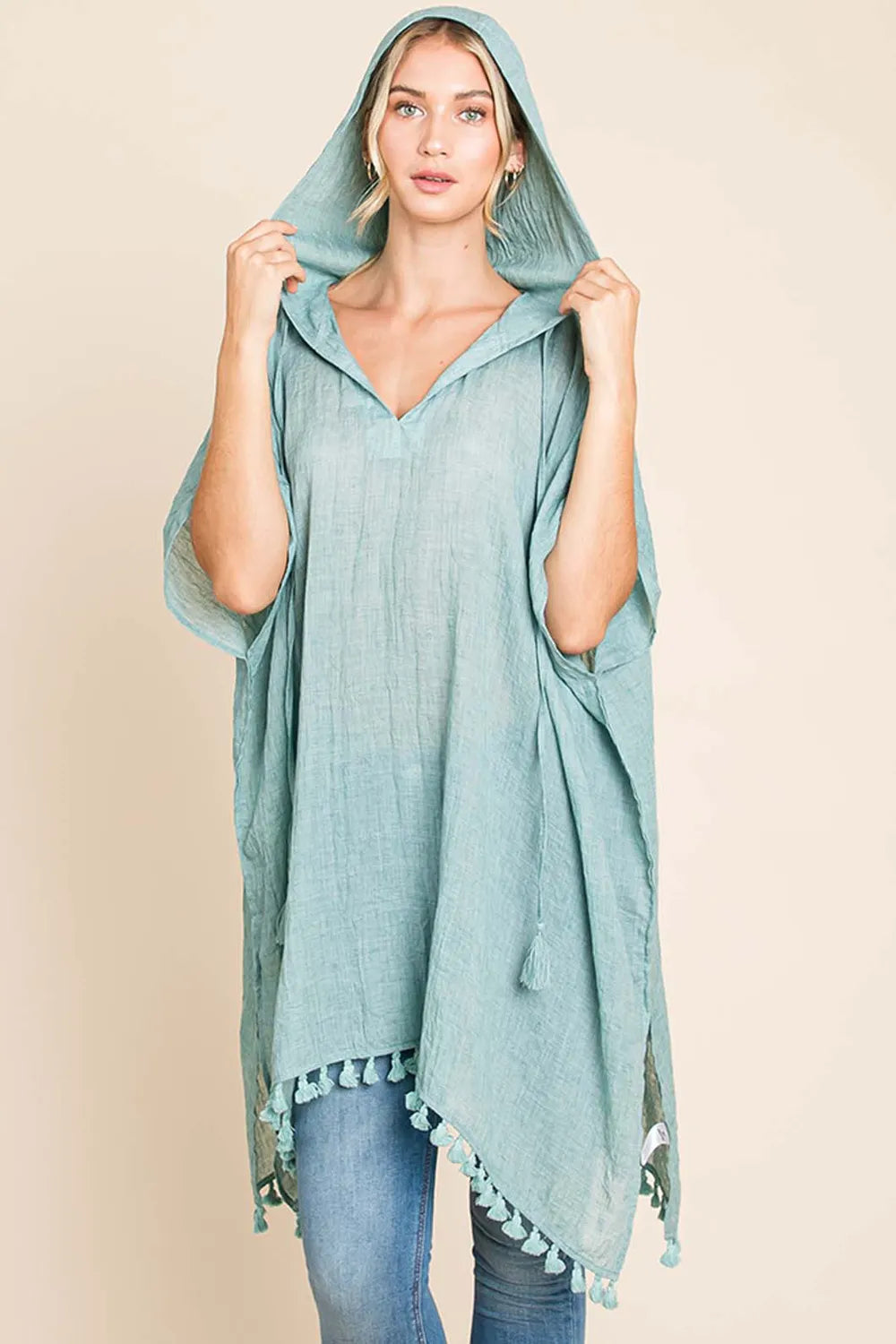 Women's cotton hooded beach cover-up dress with tassel hem, featuring a relaxed fit and lightweight fabric for summer wear.
