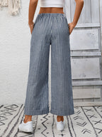 Women’s striped wide-leg drawstring pants with pockets, stylish and comfortable Trendsi pants worn with a casual top.