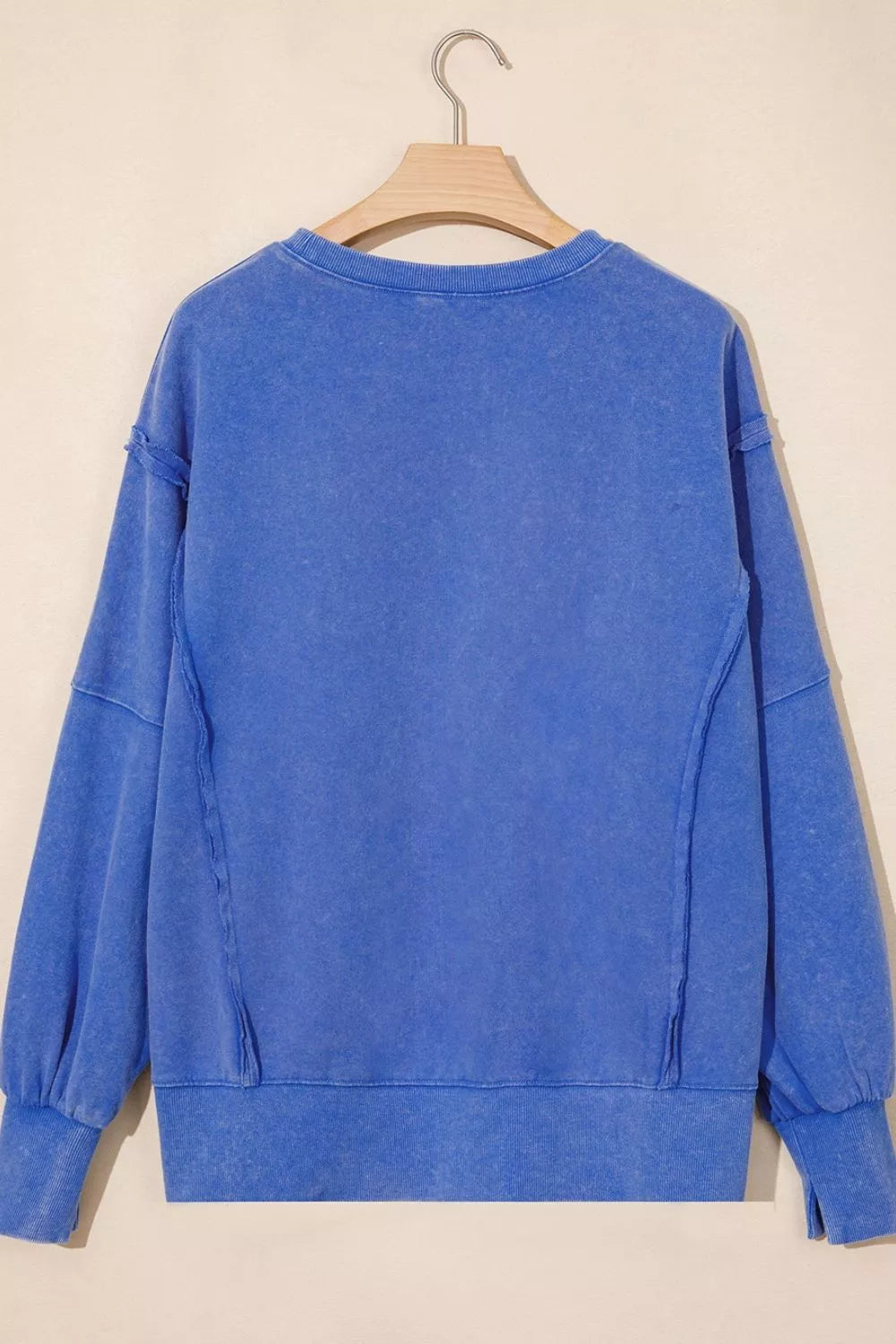 Mineral wash split hem loose tunic sweatshirt by Trendsi, featuring a relaxed fit and casual style, with a soft, washed fabric appearance.