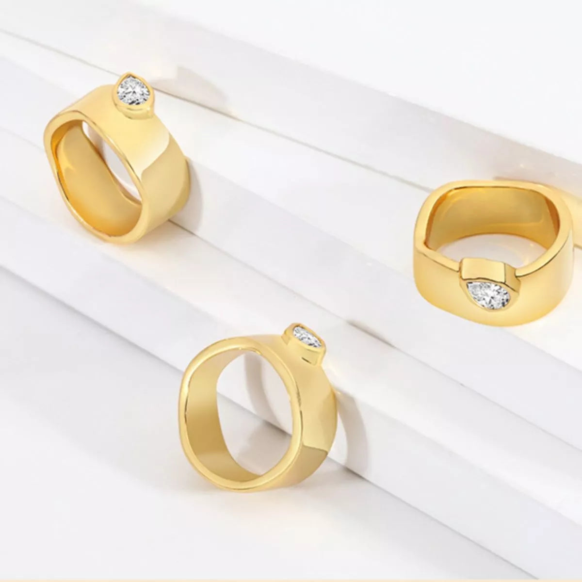 18K gold-plated minimalist ring featuring sleek, modern design from Plush Fashion Hub, displayed on a neutral background.