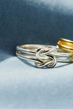 925 Sterling Silver Knotted Ring, elegant jewelry piece with a twisted knot design, showcasing craftsmanship and shine.