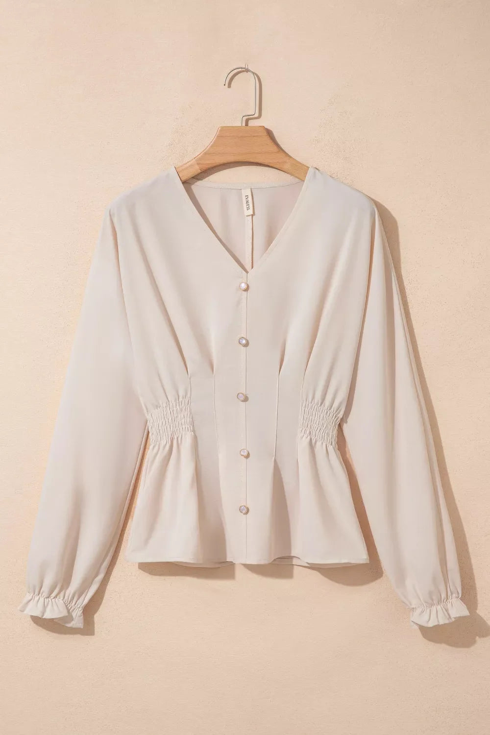 V-neck long sleeve blouse with smocked waist from Plush Fashion Hub, featuring an elegant design and soft fabric.