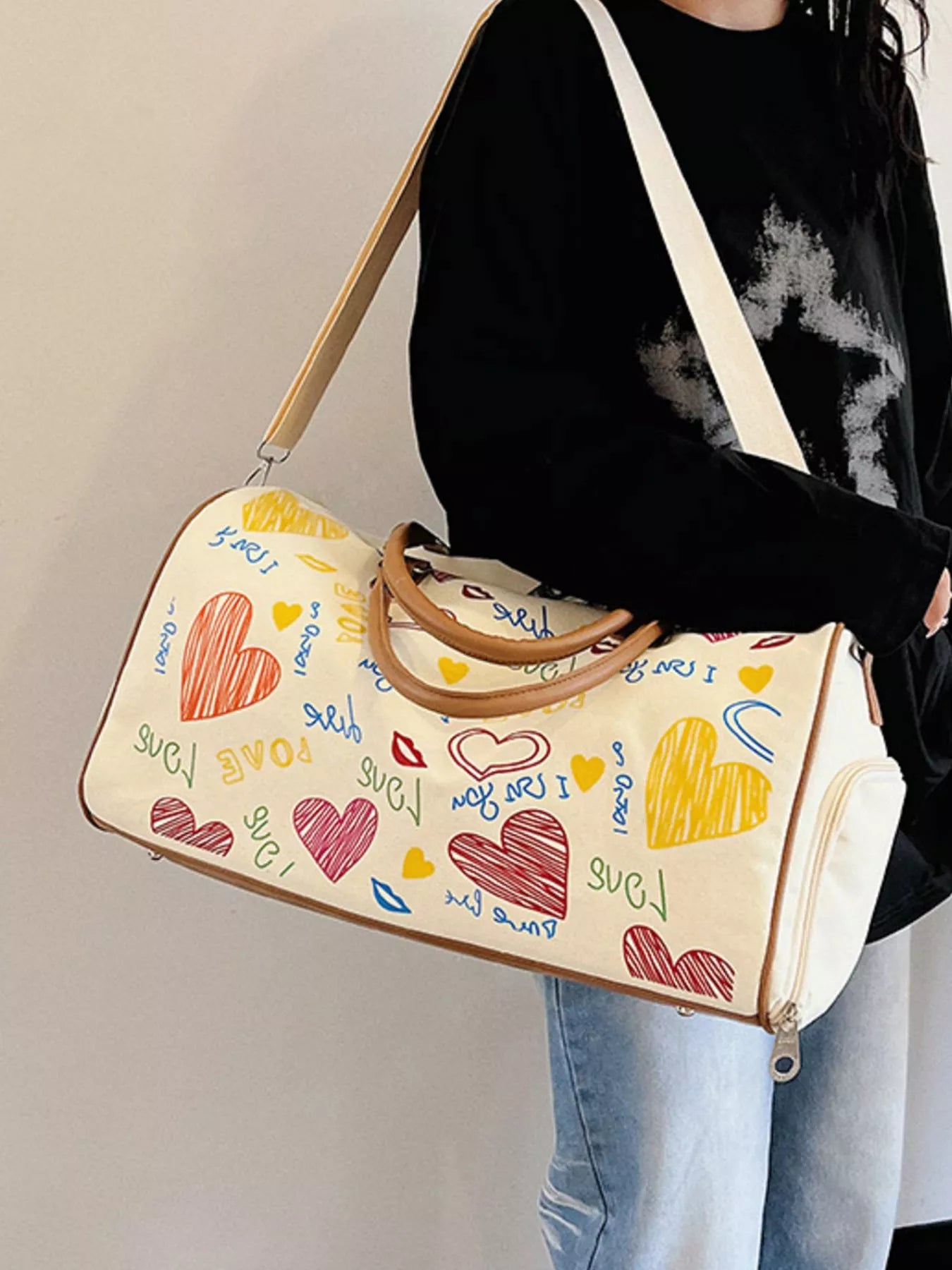 Printed duffel bag with adjustable strap from Plush Fashion Hub, showing a spacious bag with a colorful printed design.