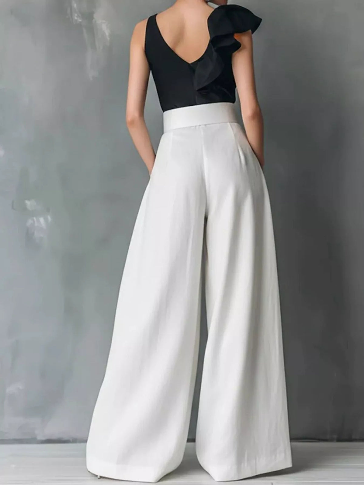 High-waisted wide-leg pants by Plush Fashion Hub, shown in neutral fabric with a relaxed fit and flowy silhouette.