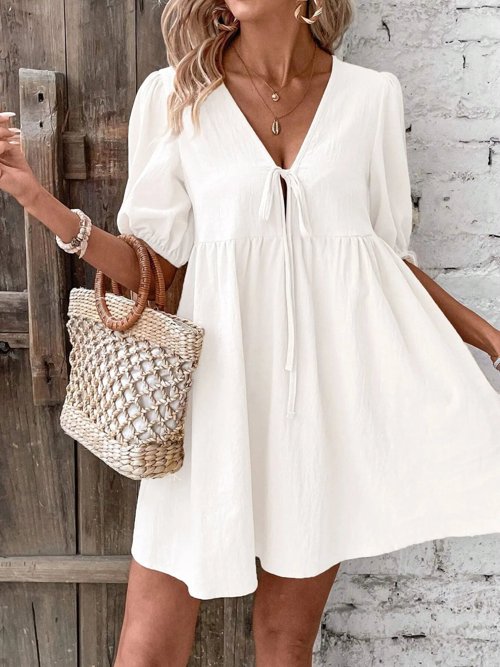 Cotton V-neck tie-front mini dress with puff sleeves, stylish and lightweight, by Trendsi.