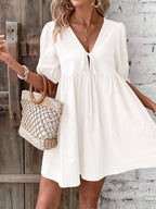 Cotton V-neck tie-front mini dress with puff sleeves, stylish and lightweight, by Trendsi.