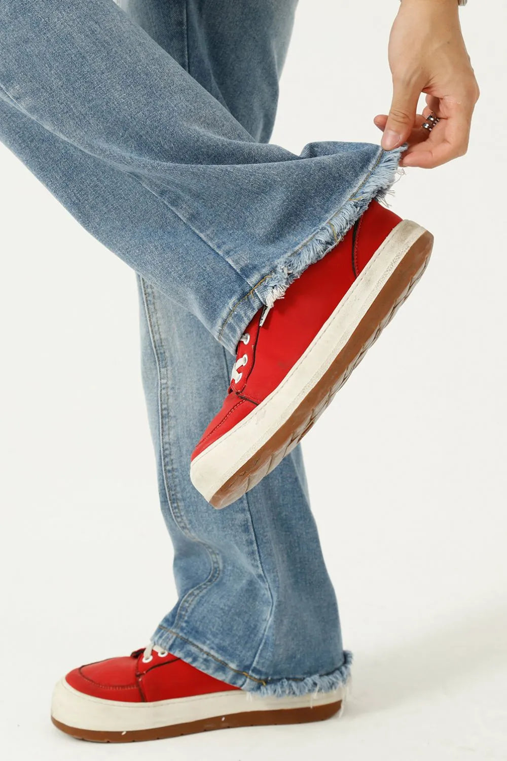 Raw hem denim jeans with pockets from Trendsi, showing distressed edges, classic five-pocket design, and casual fit.