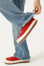 Raw hem denim jeans with pockets from Trendsi, showing distressed edges, classic five-pocket design, and casual fit.