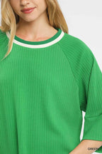 FitiqueFit Umgee ribbed knit top with contrast trim, showing the fitted design and stylish neckline in a close-up view.
