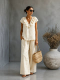 Women's V-neck ruffled hem top and wide-leg pants casual two-piece set by Plush Fashion Hub, shown in a stylish, relaxed fit.