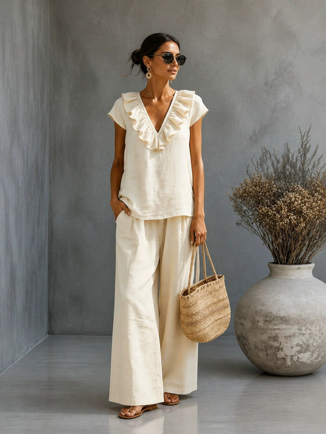Women's V-neck ruffled hem top and wide-leg pants casual two-piece set by Plush Fashion Hub, shown in a stylish, relaxed fit.