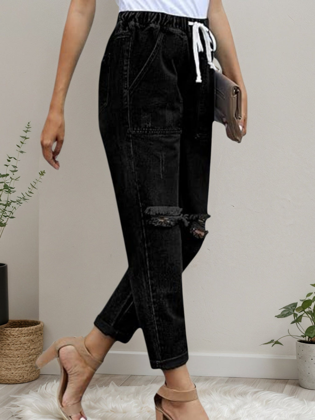 Women’s distressed stretch denim joggers with casual elastic waist, made by Plush Fashion Hub, featuring a relaxed fit and distressed details.