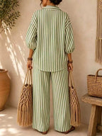 Plus size striped puff sleeve shirt and wide-leg drawstring pants set by Trendsi, featuring comfortable fabric and stylish design.