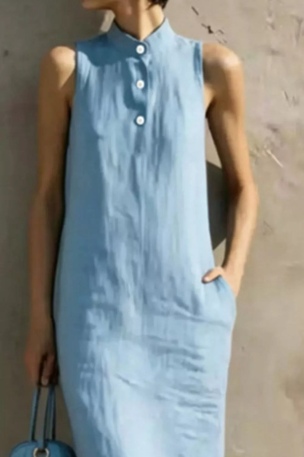 Casual sleeveless midi dress with button details from Trendsi, featuring a relaxed fit and stylish design perfect for summer wear.