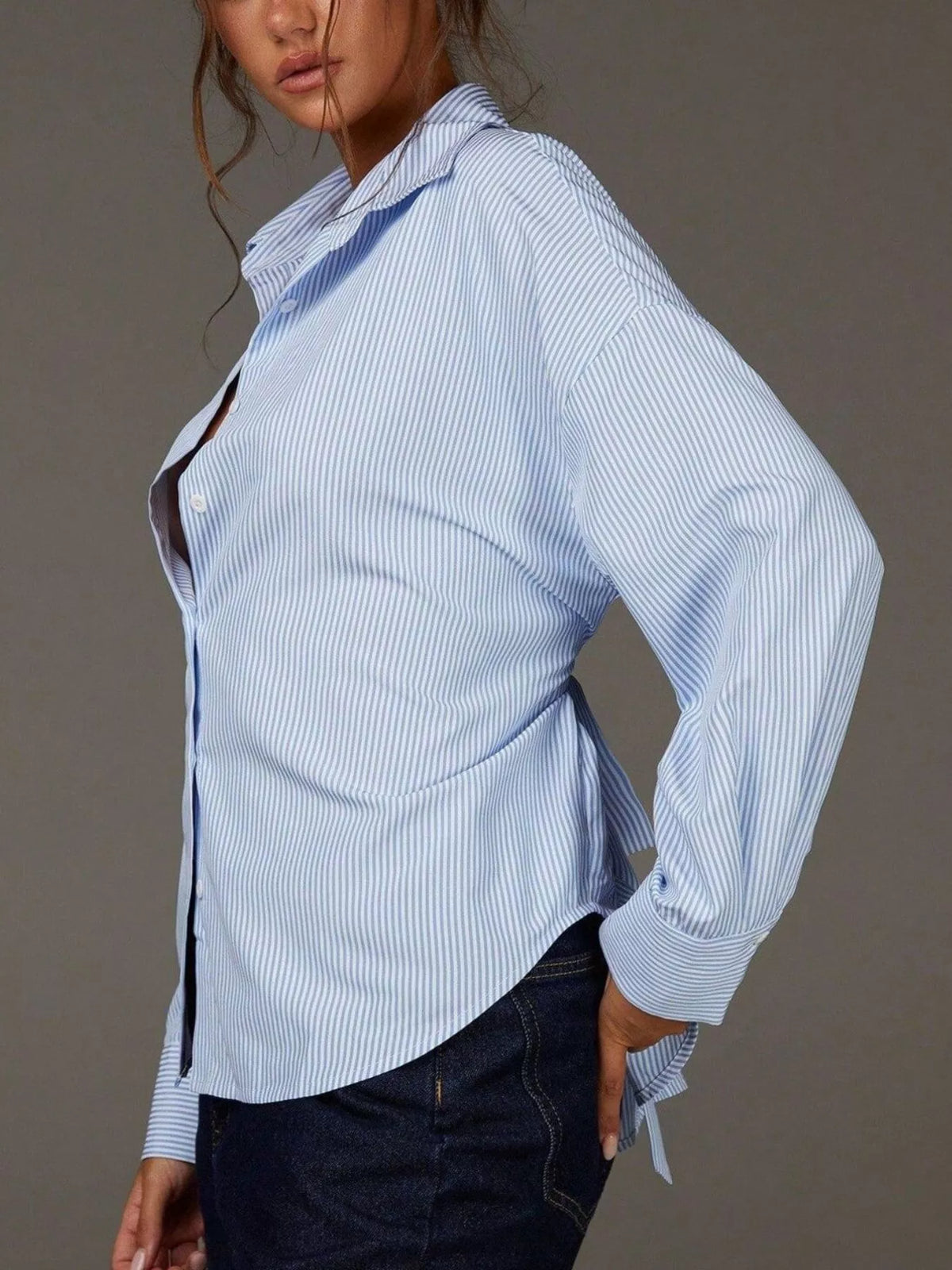 Casual striped button-down shirt by Trendsi featuring a classic collar, long sleeves, and a relaxed fit.