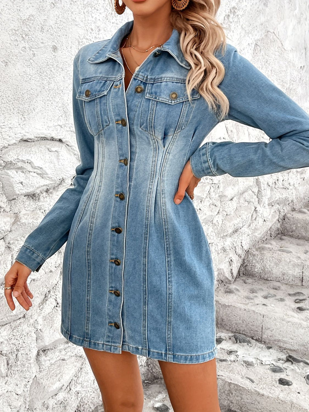 VYSN pocketed button-up long sleeve denim dress hanging on a rack, showcasing its classic collar and front patch pockets.