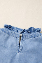 Women's distressed denim top by Trendsi with frilled collar and flutter sleeves, featuring a casual, trendy design.