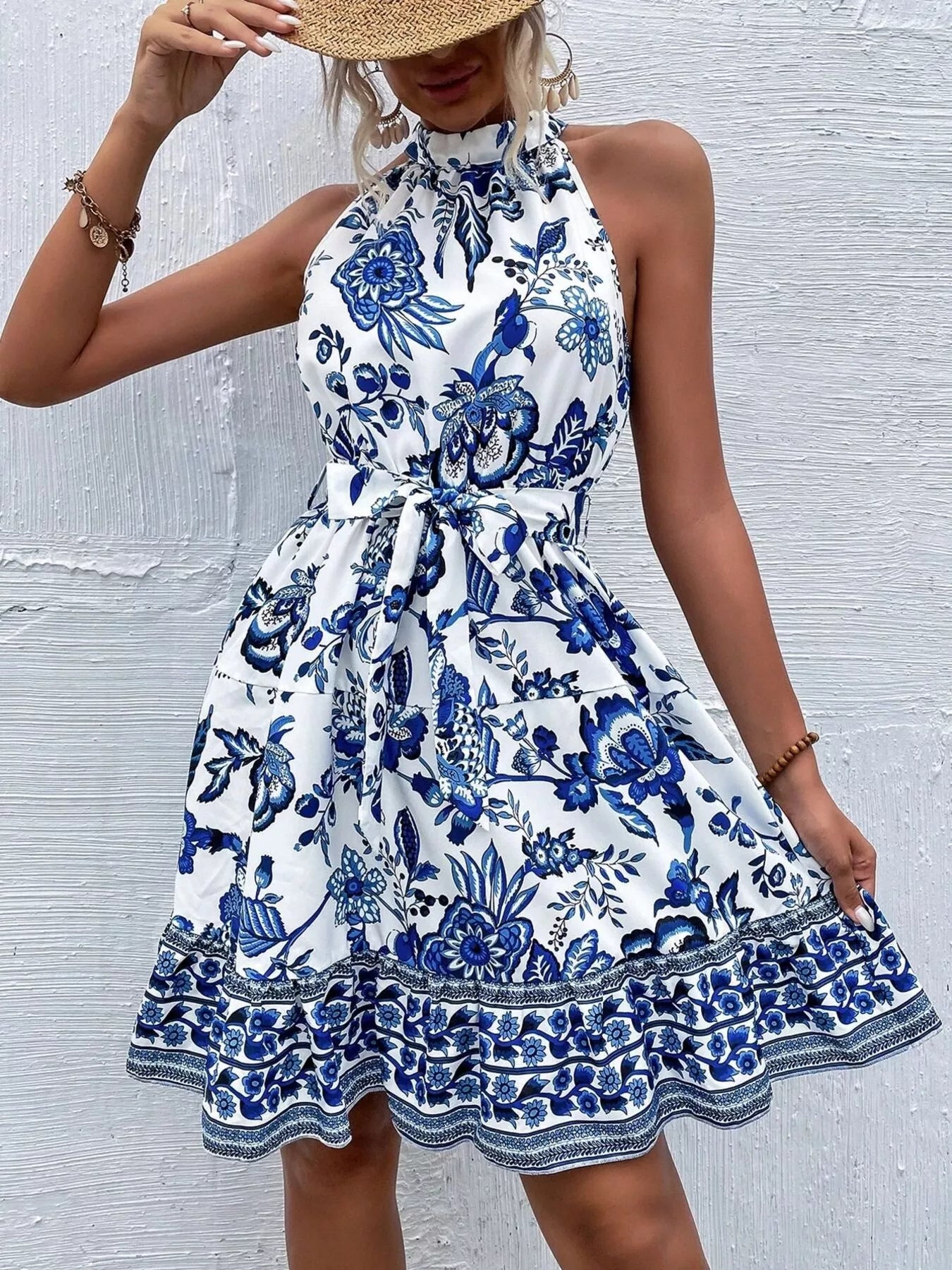 Printed sleeveless tie waist dress by Shopimist featuring a flowy fabric and stylish design, perfect for warm weather.